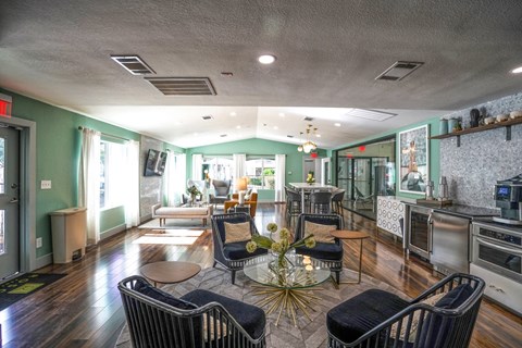 a living room with chairs and a table
